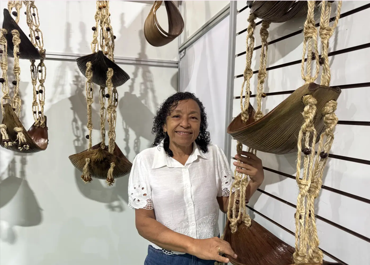Artesã paraense, Léa de Souza Silva, posa ao lado de seu trabalho no evento: "Sem o apoio da Seaster, a gente não conseguiria"